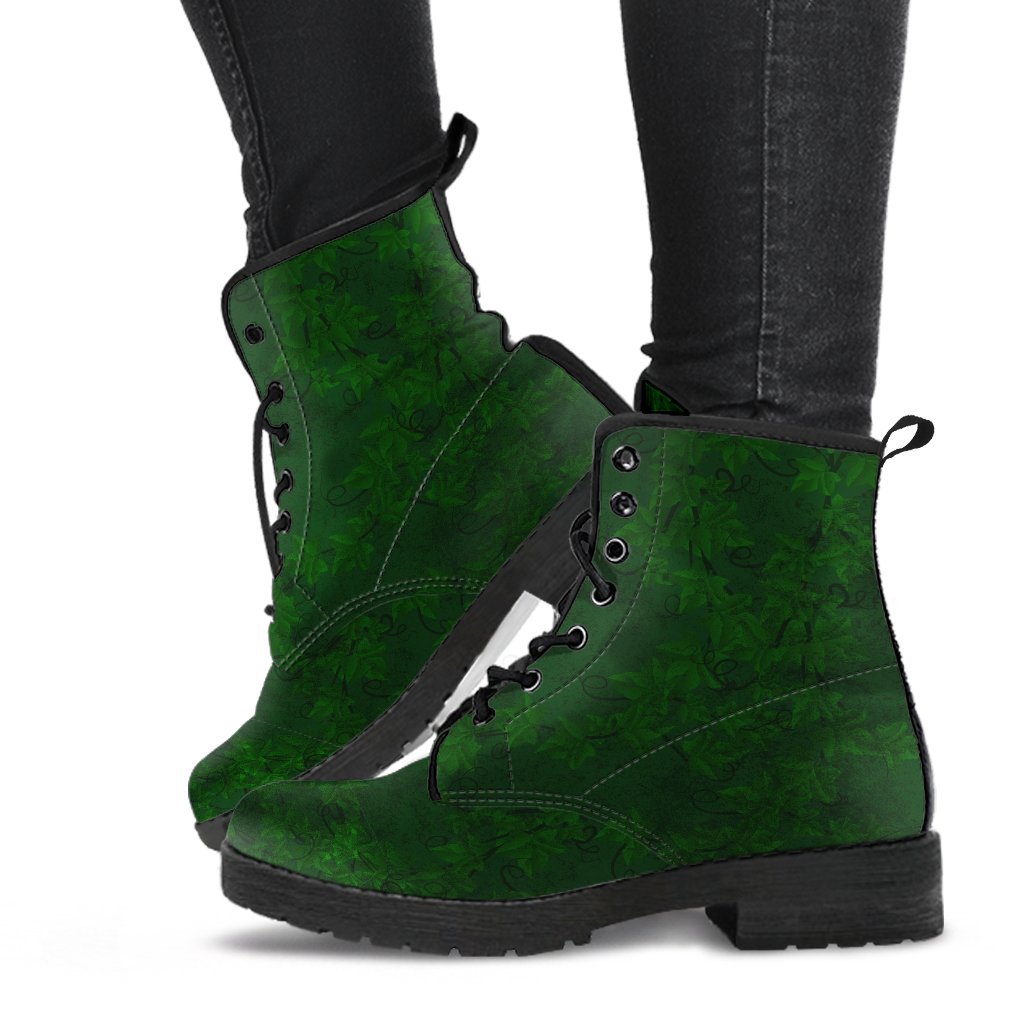 image shows lace up combat style boots with black soles and black lacing custom printed with a deep green print of ivy. boots are just above ankle length