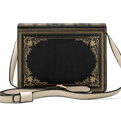 Black handbag with gold detailing on a white background