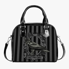 gothic handbag featuring grey and black stripes with a picture of a raven and the words nevermore underneath. The overall look of the bag is gothic and the bag has black handles and a shoulder strap