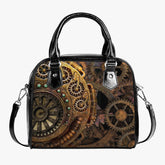 steampunk handbag with black handles and shoulder strap. Features a print of bronze and gold toned clockwork gears. Shoulder purse is approximately 9 inches wide and 8 inches high