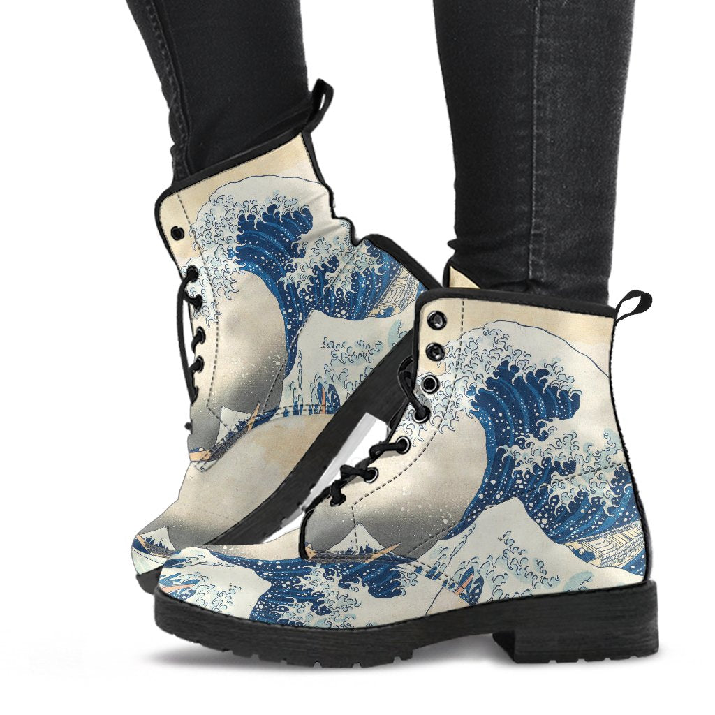 the great wave woodcut custom printed onto a combat style boot, just above ankle length, the boots have black soles and black lacing.