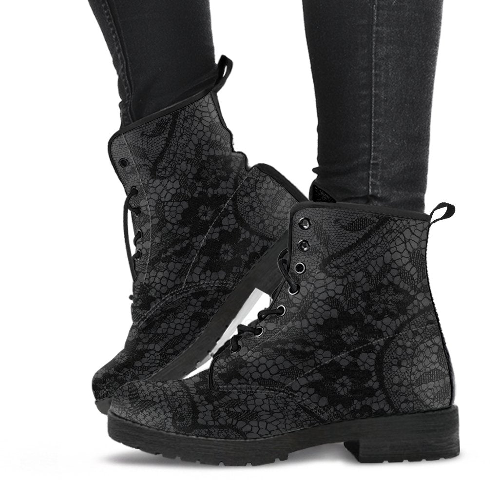 image shows a black and grey lace up combat style boot with a black lace print on a grey background.  The sole and laces of the boots are black and overall the boots have a gothic vibe.