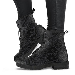image shows a black and grey lace up combat style boot with a black lace print on a grey background.  The sole and laces of the boots are black and overall the boots have a gothic vibe.