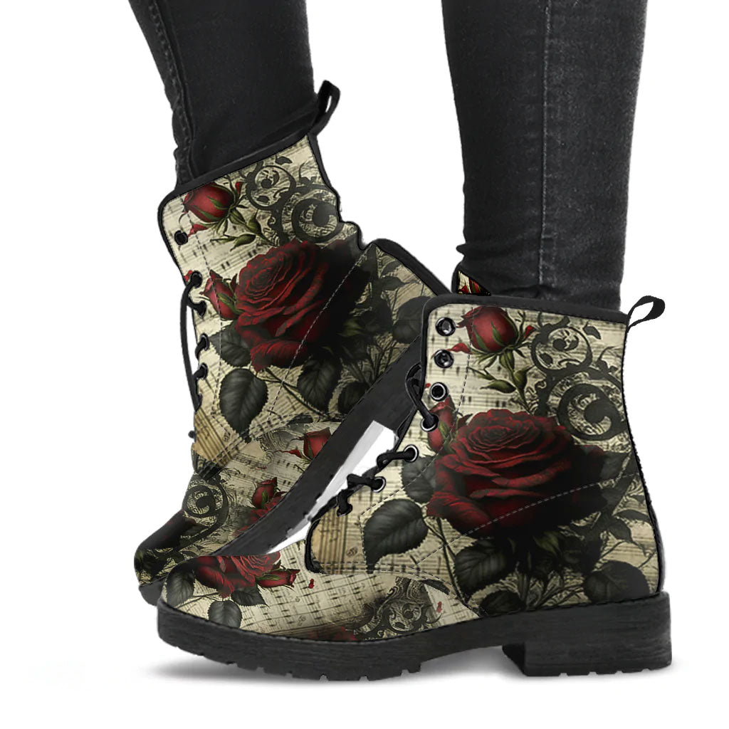 image shows lace up combat boots with black soles and black laces. The boots are just above ankle length and feature a custom print of dark red roses and sheet music. Gothic Style.
