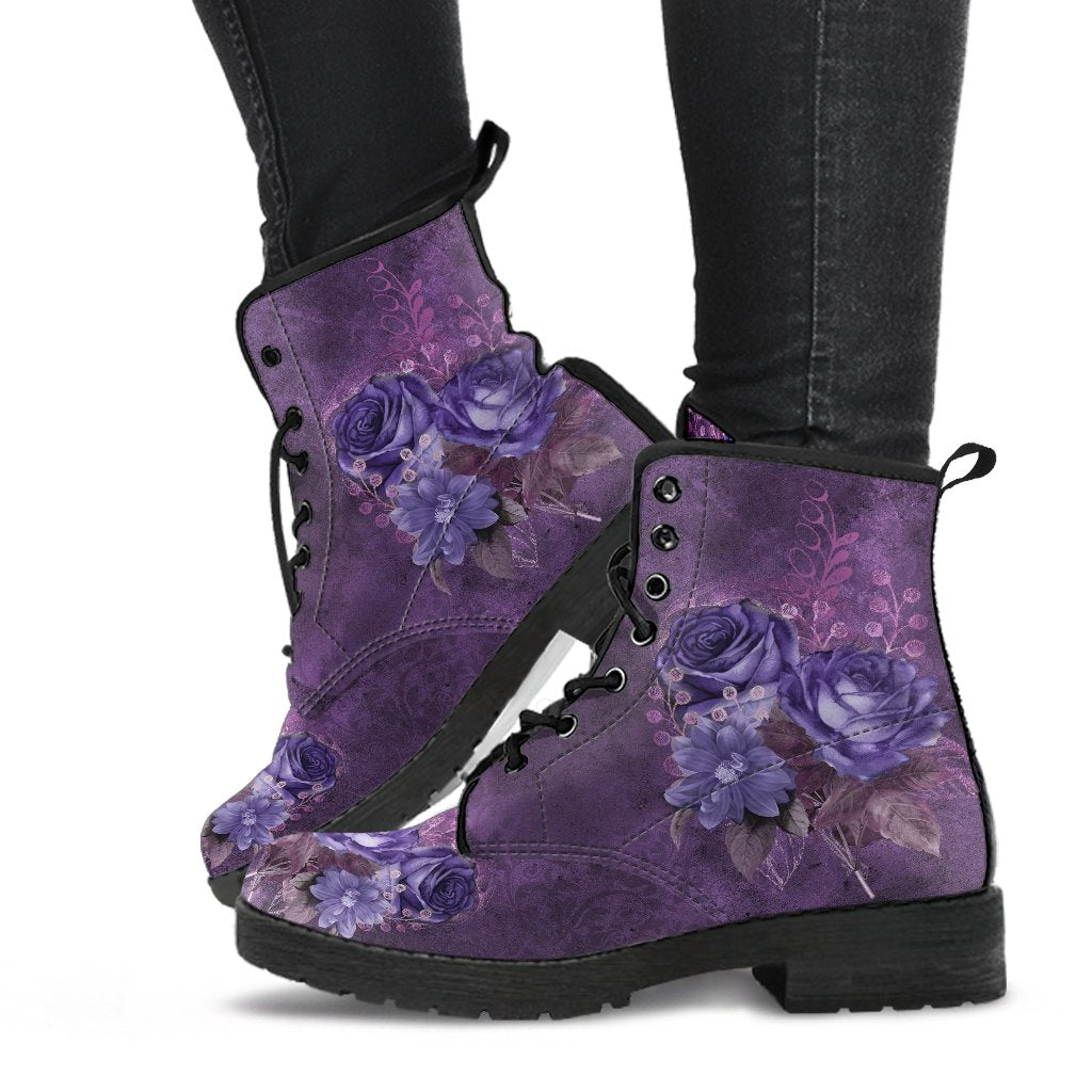 image shows a pair of lace up combat boots with black soles and lacing, just above ankle length.  These boots feature a print of purple gothic roses on a purple grunge background.