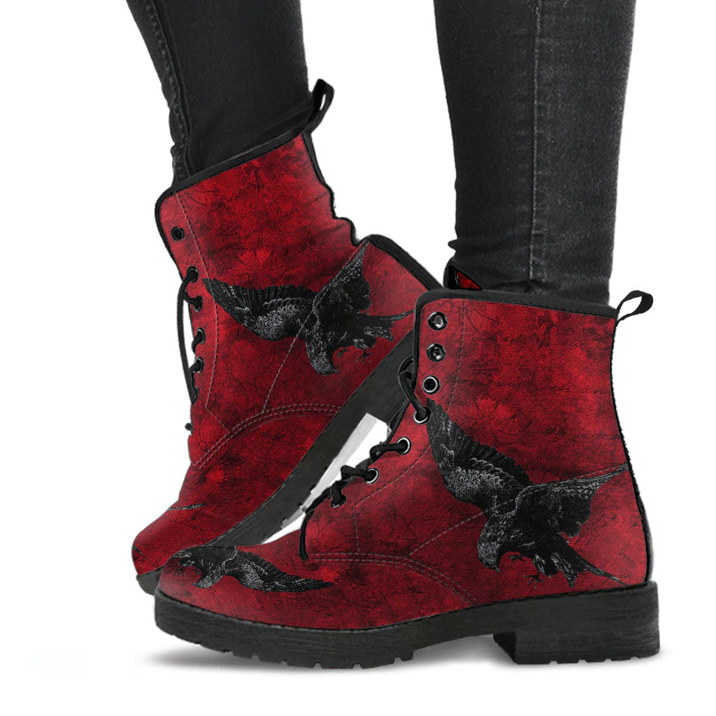 image shows blood red lace up combat boots, just above ankle length.  Boots feature a blood red grungy background with a swooping raven in black on the sides and toes.