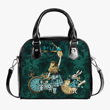 Load image into Gallery viewer, Alice in Wonderland bottle green handbag with alice and the cheshire cat. Alice and friends are in pastel green. Alice is reaching up for the &#39;drink me&#39; bottle watched over by the cheshire cat. The background is a deep green damask print.
