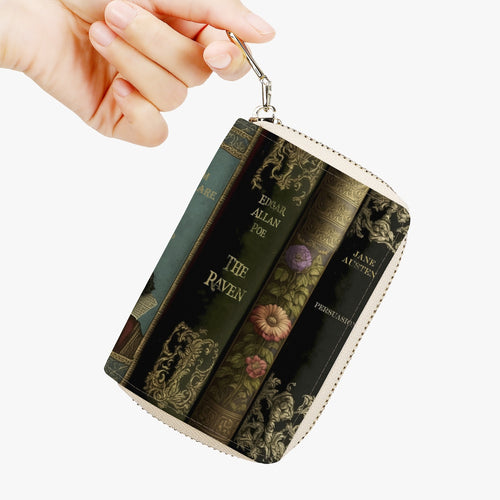 small zippered wallet featuring a print of vintage books including titles by shakespeare, jane austen and edgar allan poe.  