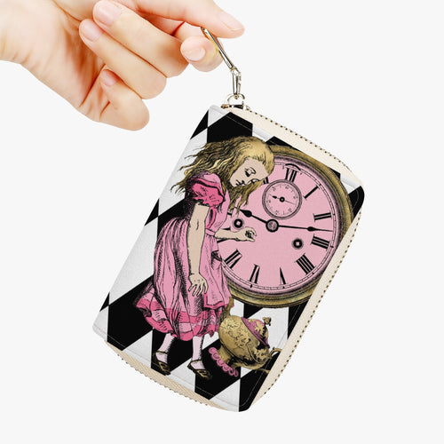 image shows a small credit card wallet with a zipper.  Custom printed with a black and white diamond bacground and a feature print of Alice tumbling down the rabbit hole in pink with a clock face behind her in gold. on the back of the wallet is the white rabbit in pink and gold. 
