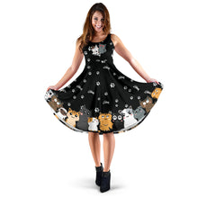 Load image into Gallery viewer, black sleeveless sundress with cute cartoon style cats in black white, grey and brown printed around the bottom of the full skirt.  The background print is of cat paw prints and fish bones.  Very cute dress
