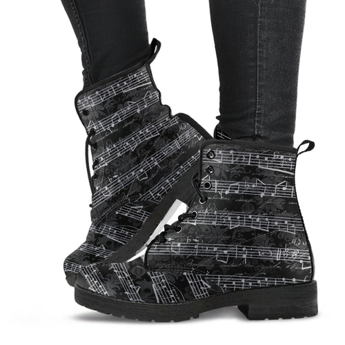 black vintage sheet music lace up combat boots.  Black grungy vintage writing background over printed with sheet music in white. 