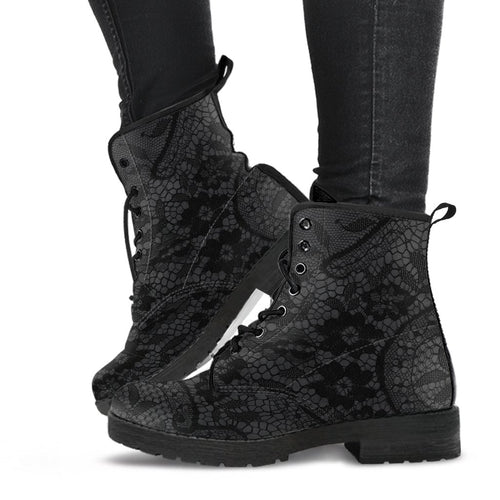 image shows a black and grey lace up combat style boot with a black lace print on a grey background.  The sole and laces of the boots are black and overall the boots have a gothic vibe. 