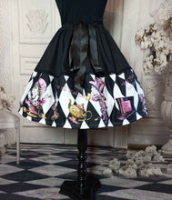 Load image into Gallery viewer, alice in wonderland mad hatter tea party full fifties style skirt.  The skirt features the mad hatter, teacups, teapots and top hats in pinks and golds on a black and white diamond print background.  The upper half of the skirt is black with a decorative ribbon tie at the fully adjustable waist
